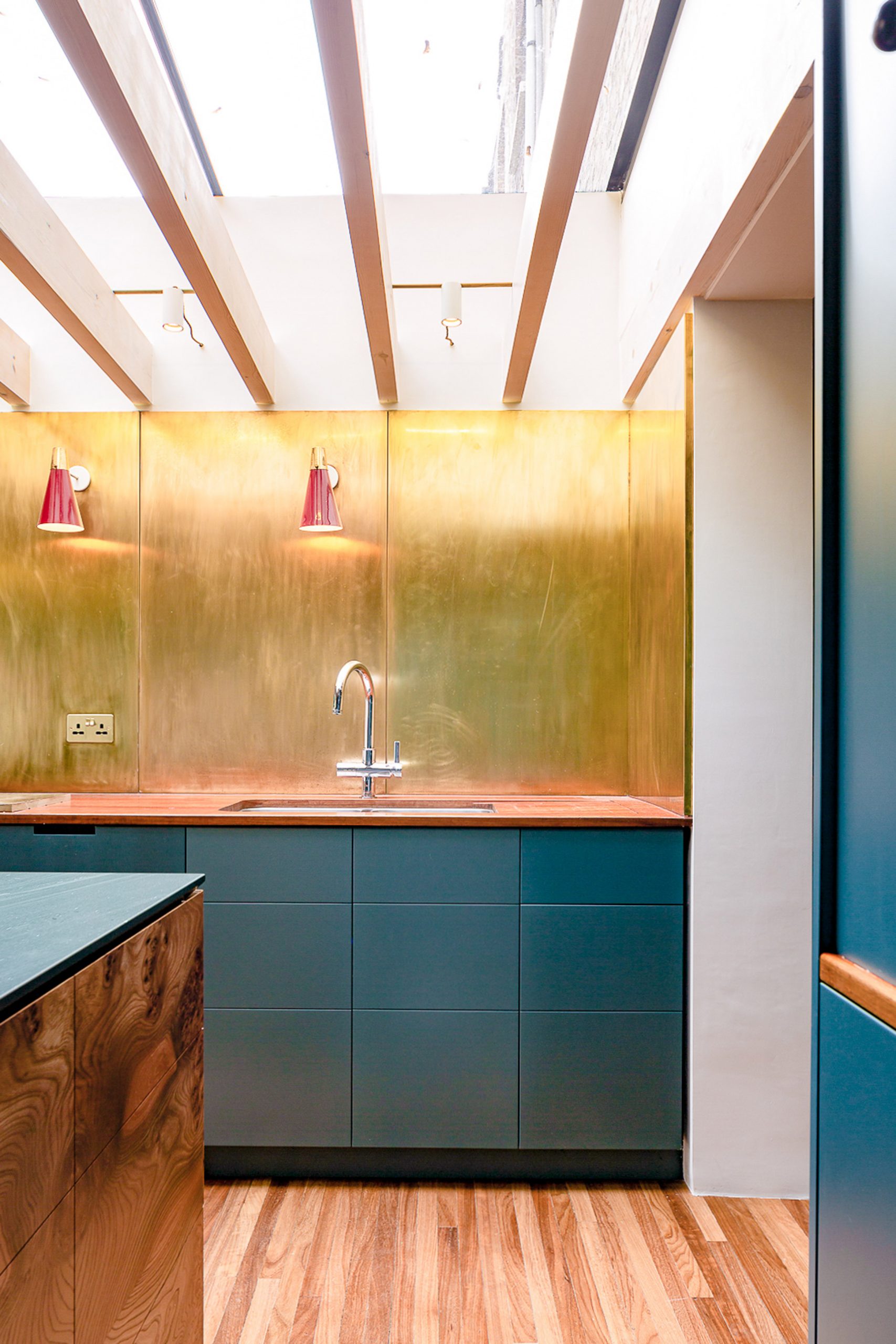 Gold and blue contrasting kitchen in a London home