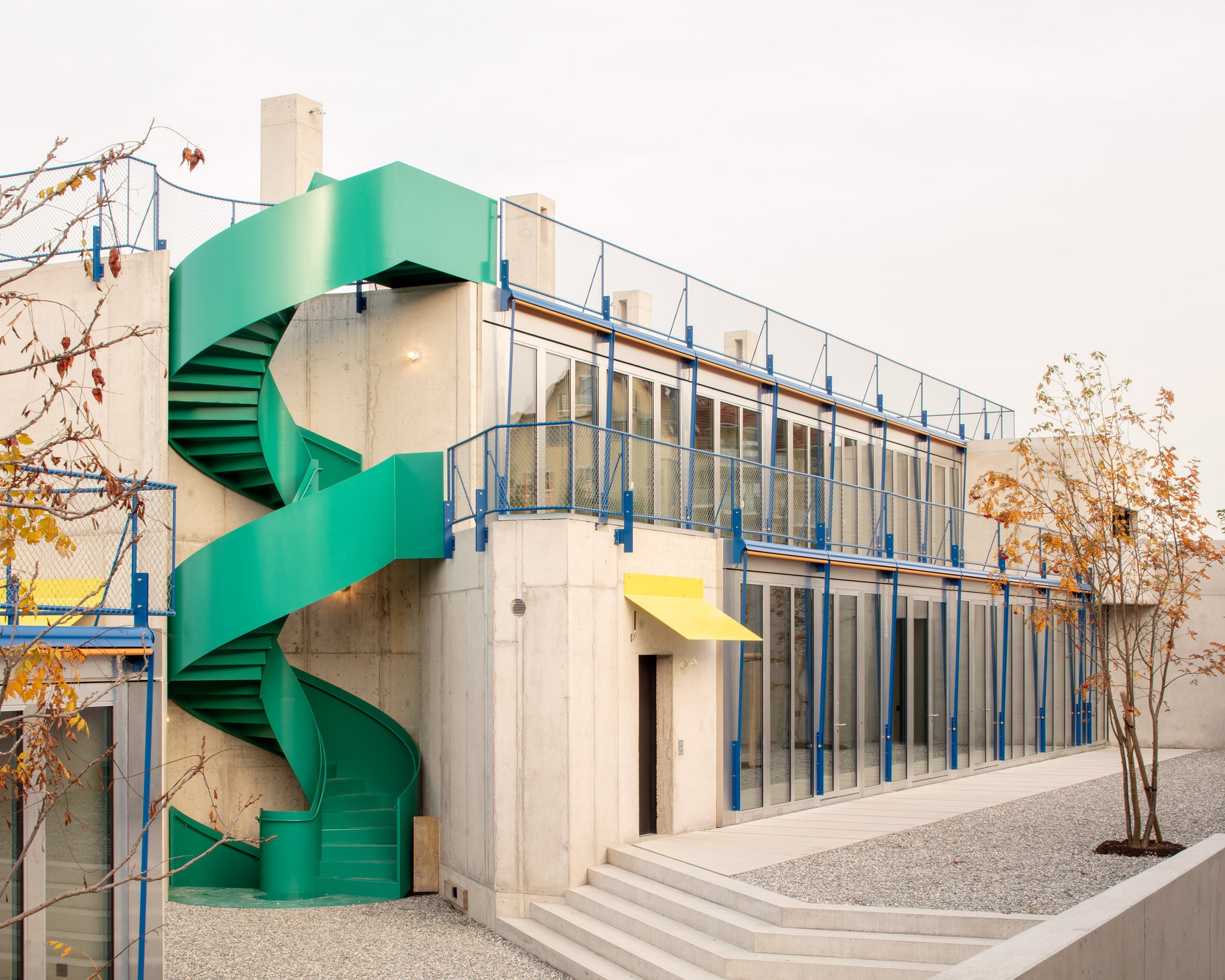 Courtyard area with spiral staircase at concrete residences