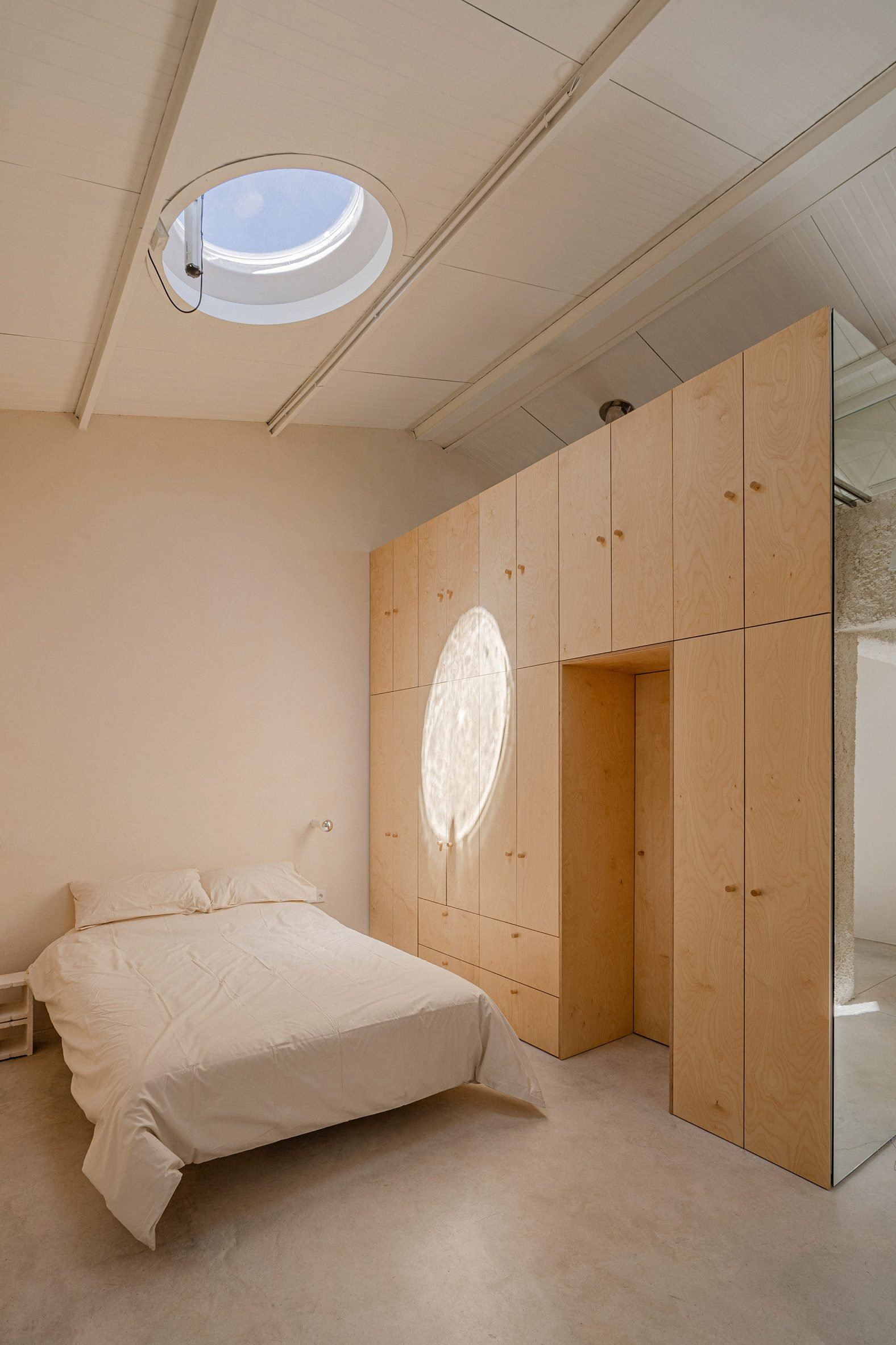 Bedroom interior at Madrid warehouse conversion by Burr Studio