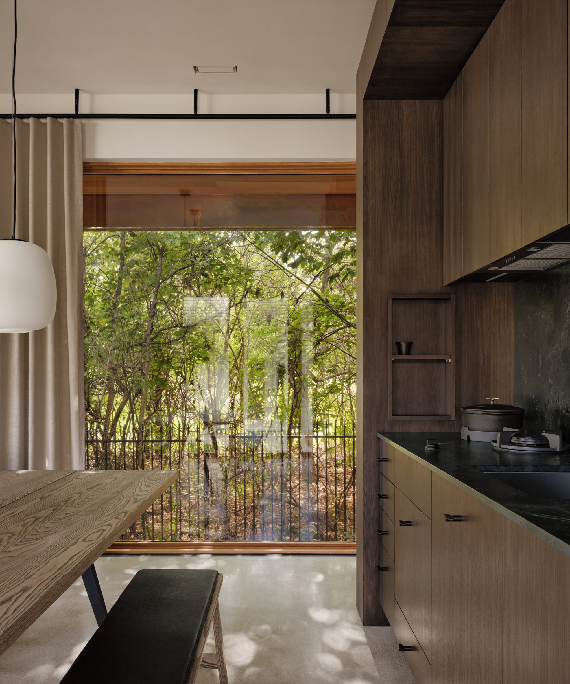 Neutral-toned kitchen overlooking a garden