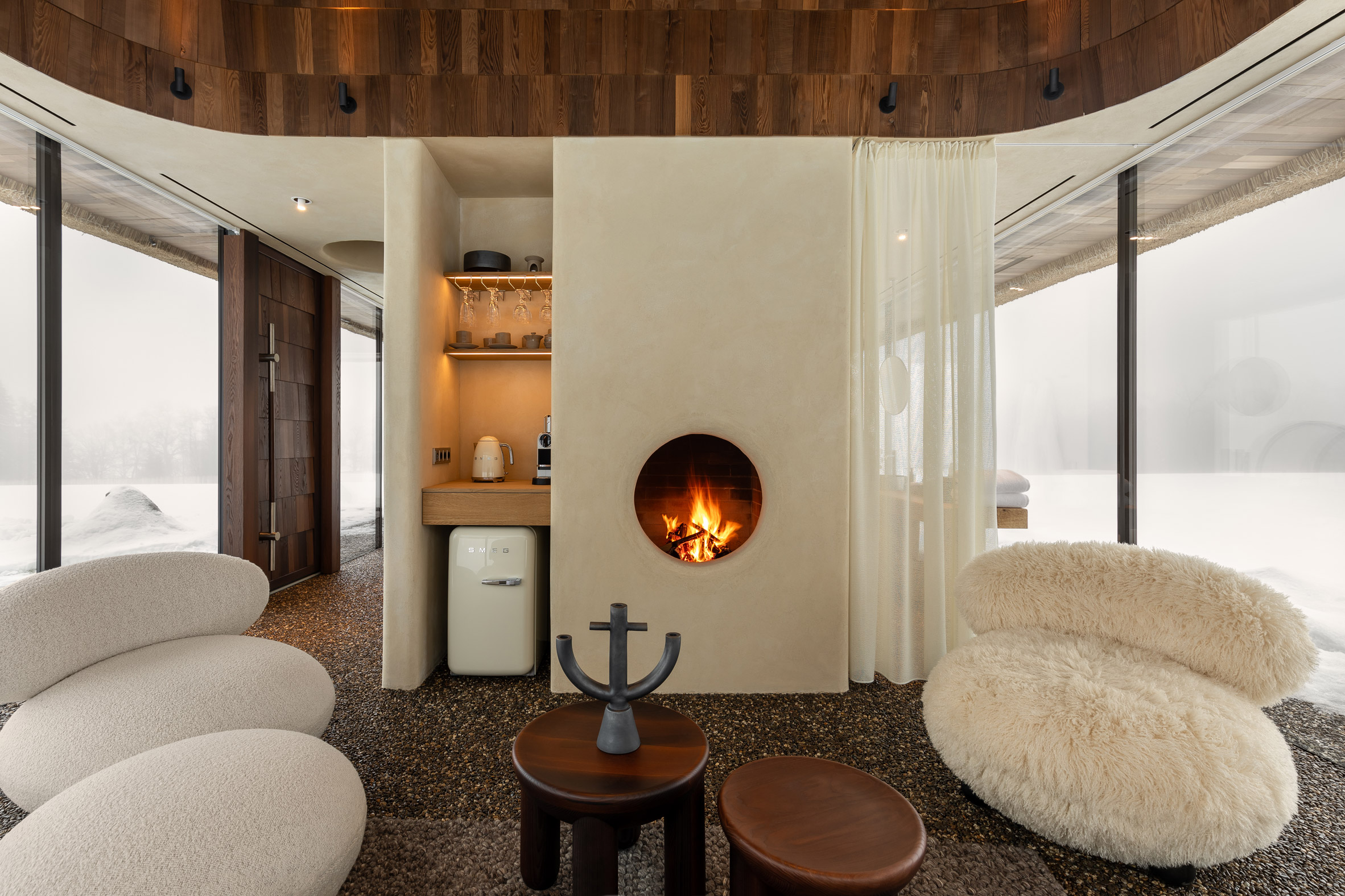 Neutral interior inside glass-walled hut