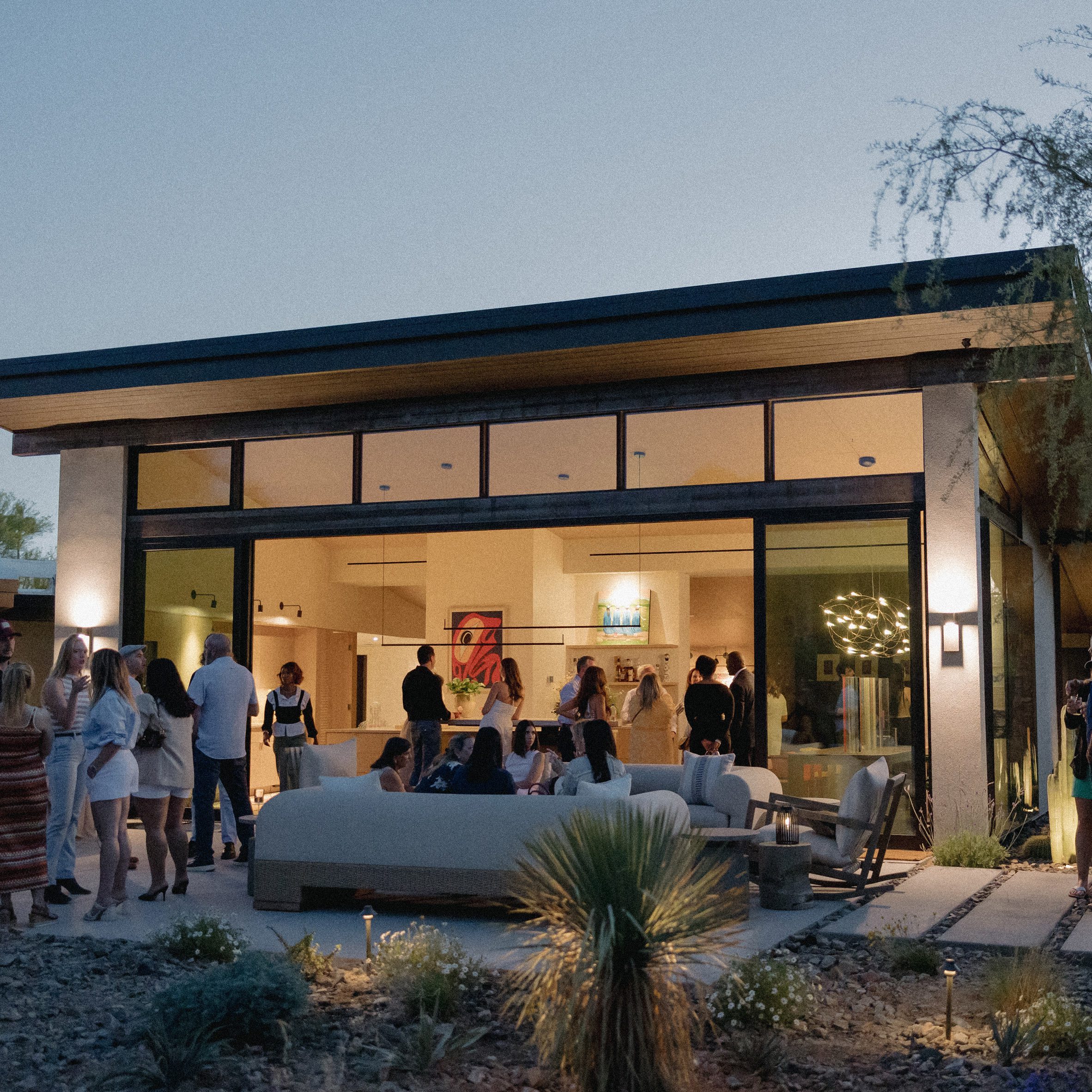 Photo of people stood in the garden of a house