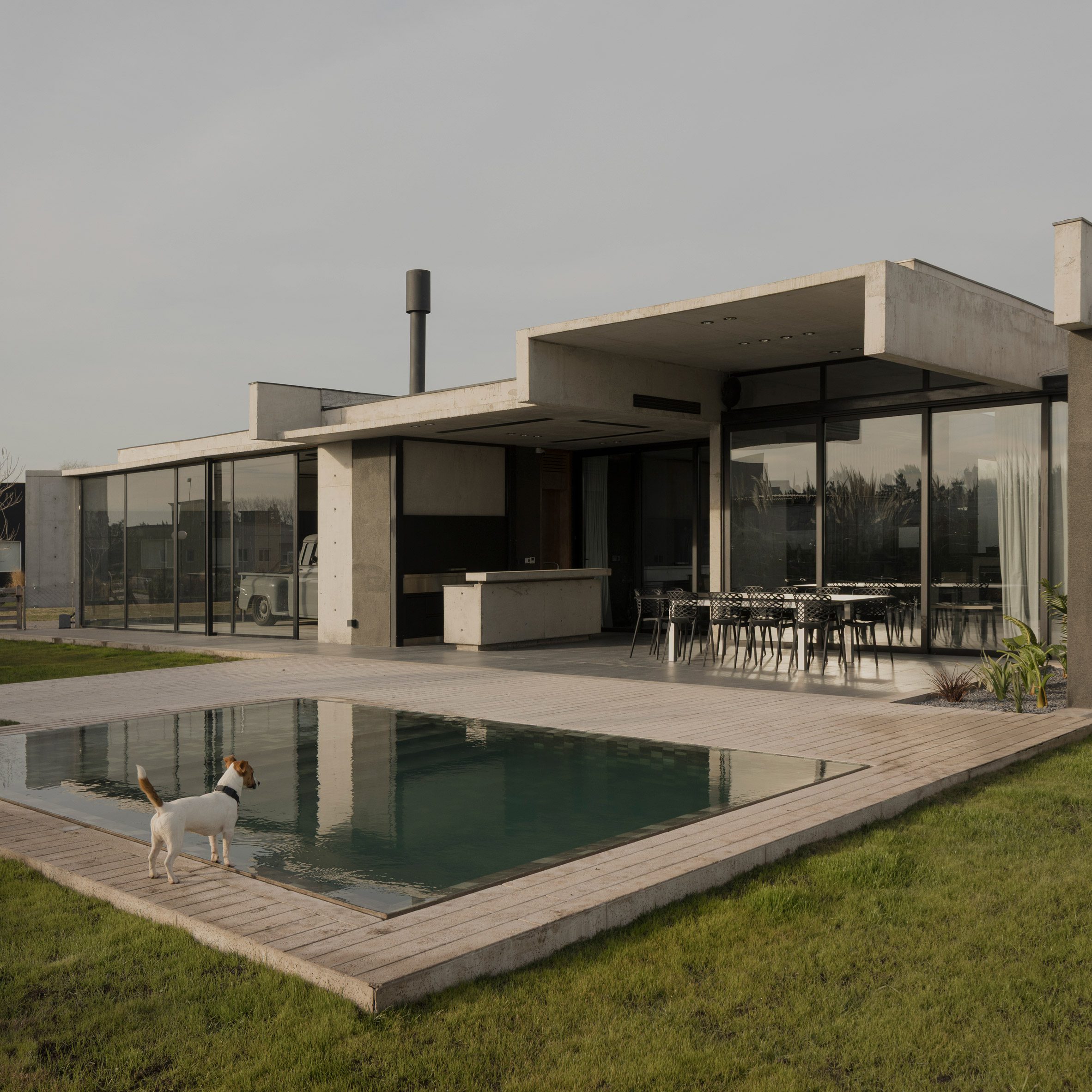 Casa Alba by Ademas Arquitectura, a concrete house with a wall for privacy