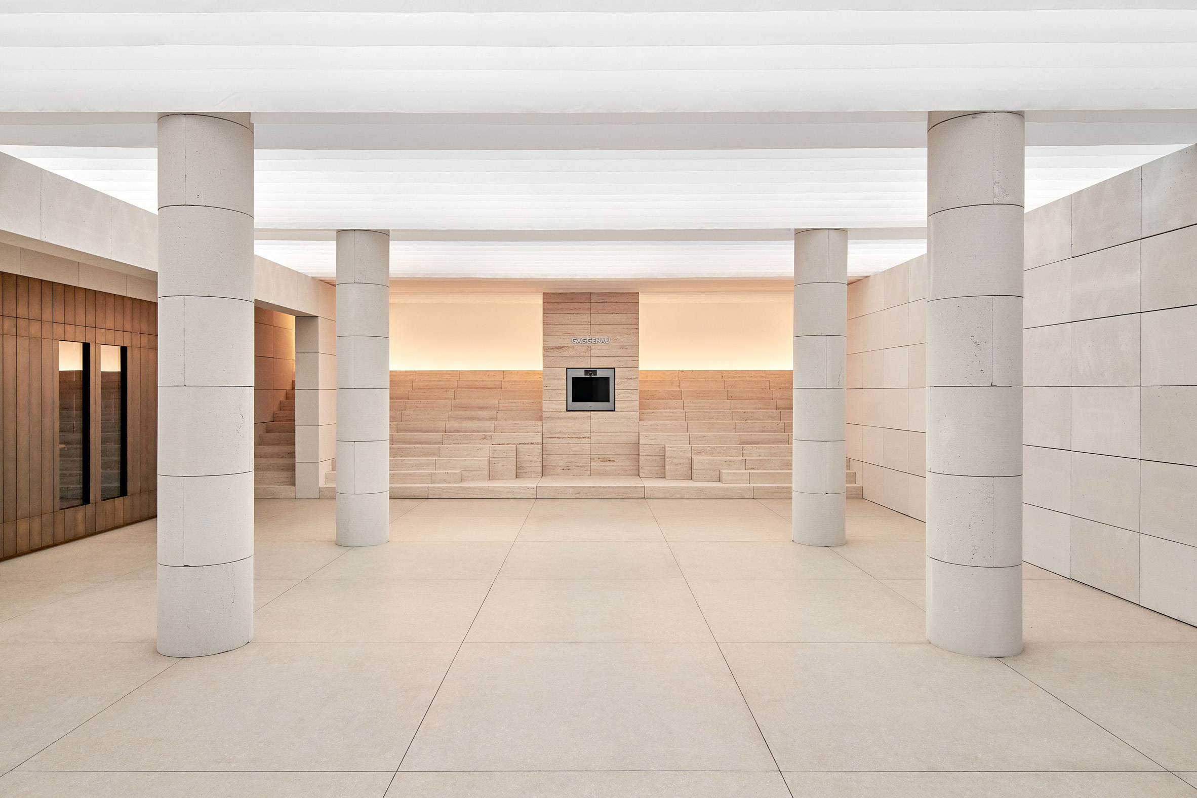 Stepped stone seating and a built-in oven form the centrepiece of Gaggenau's Presence installation