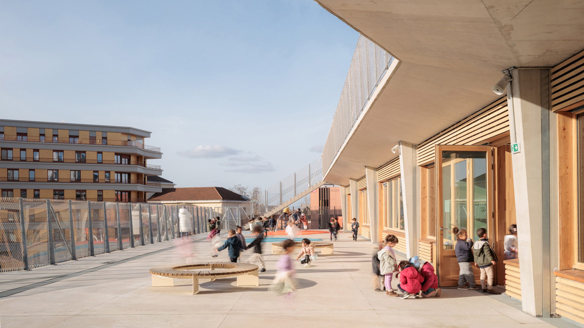 Children playing on a terrace outside classrooms at the school